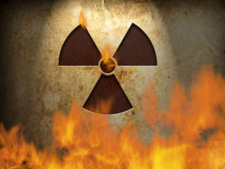 Nuclear symbol on wall with fireの写真素材
