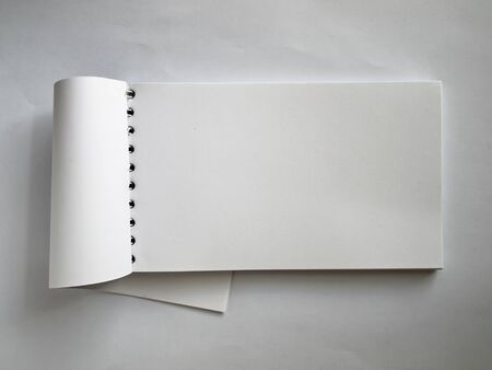 White Horizontal note book open on paper backgroundの写真素材