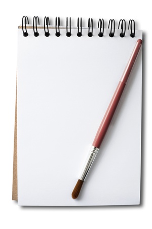 Brush handle in red on a white sketch book and white backgroundの写真素材