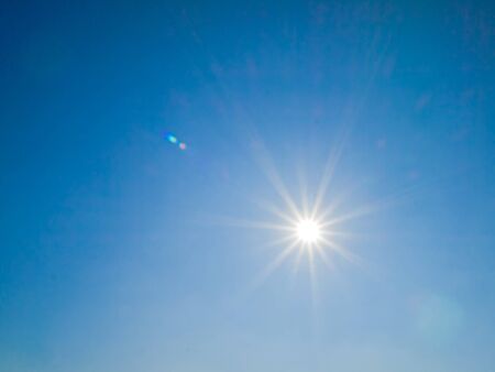 The sun shines on a blue skyの写真素材