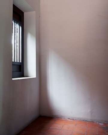 The light from the windows in the white room red floorの写真素材