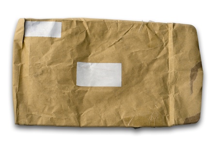 Old wrinkled brown paper envelope and a white labelの写真素材