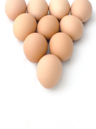 Egg arranged in triangle on white backgroundの写真素材