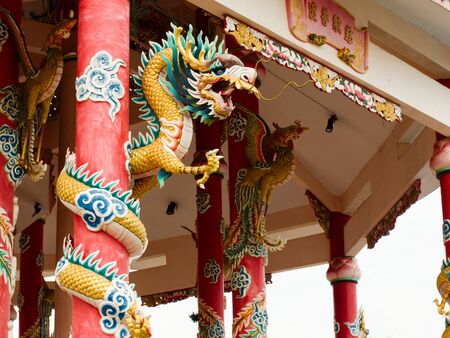Left Golden dragon statue on red pillar in Chinese Temple styleのeditorial素材