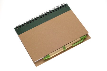 Recycle paper notebook and pen isolated on white backgroundの写真素材