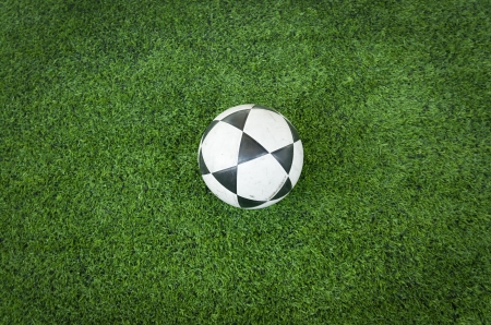 Black and white soccer ball on Artificial turf football fieldの写真素材