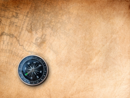Black Compass on Brown Paper with old map Print background の写真素材
