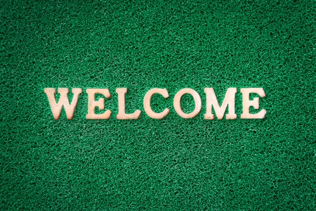 Light Welcome Text on Green Carpet Textureの写真素材