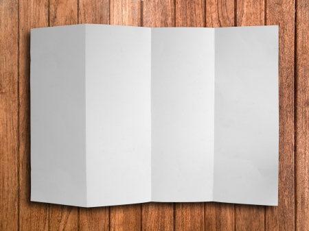 Blank Fold White Paper on Wood Background With Shadowの写真素材