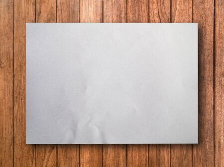 Blank White Paper on Wood Background With Shadowの写真素材