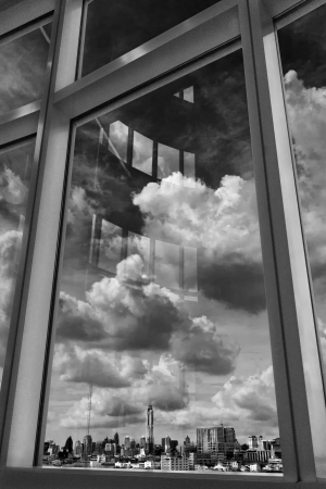 City Sky and Cloud Looking Through Window in Black and Whiteの写真素材