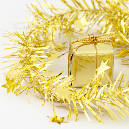 Gold Gift Box New Year and Christmas Decoration on White Tableの写真素材