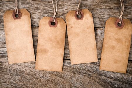 Four vertical Vintage Paper Label on Wood Backgroundの写真素材