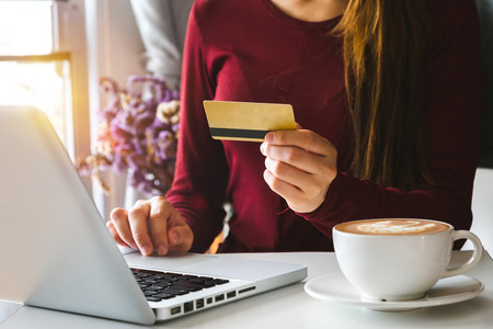 Business woman hands using smartphone and holding credit card with digital layer effect diagram as Online shopping conceptの写真素材