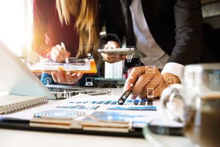 Business team partnership meeting concept. Business hand using laptop, tablet and smartphone  in office. Digital marketing media mobile app in virtual icon screen in morning lightの写真素材