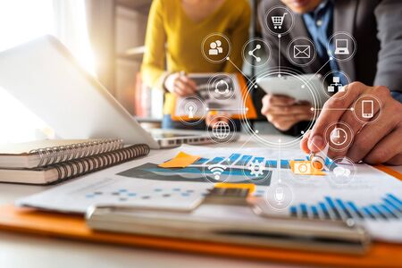 Working team meeting concept, business using laptop and smart phone and digital tablet computer with digital marketing media  in virtual icon network diagram office in morning lightの写真素材