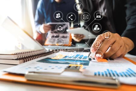 Working team meeting concept, business using laptop and smart phone and digital tablet computer with digital marketing media  in virtual icon network diagram office in morning lightの写真素材