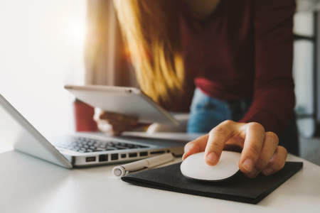 businesswoman hand using smart phone, tablet payments and holding credit card online shopping, omni channel, digital tablet docking keyboard computer at office in sun lightの写真素材