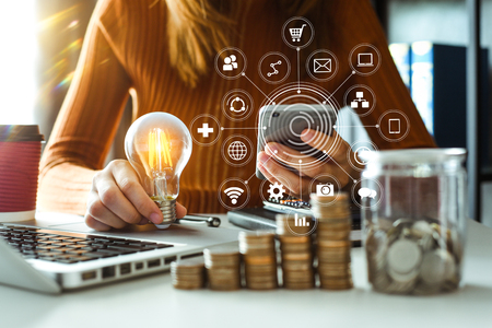 business woman using smartphone, tablet and holding light bulb, with idea with innovation and creativityの写真素材