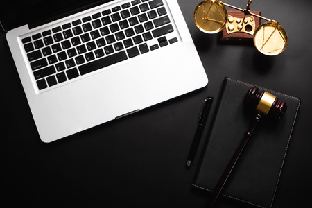 Justice and law concept.Lawyer workplace with laptop and documents with notepad,smartphome. top viewの写真素材