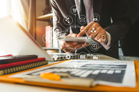 Businessman working with smart phone and laptop and digital tablet computer in  office with digital marketing media  in virtual iconの写真素材