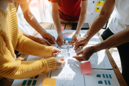 Close up view of UI developer team brainstorming on their project with laptop, smartphone and digital tablet. Creative digital development agency.の写真素材