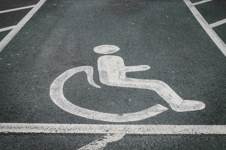 handicapped  disabled parking sign painted on the road asphaltの写真素材