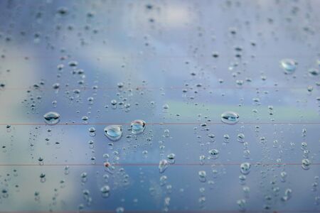 Drops of rain on car glass. Shallow depth of field. Selective focus. Toned.