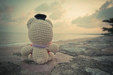 Teddy Bear sitting near the beach - vintage toneの写真素材