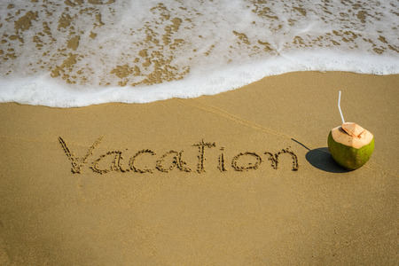 Word vacation on the beach sand - vacation and travel conceptの写真素材