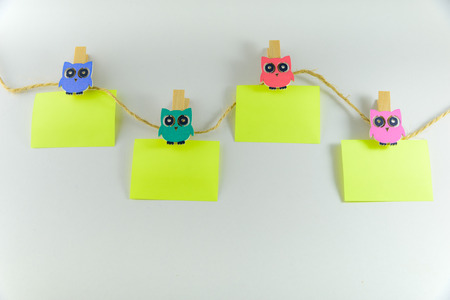 Close up of post it reminders on a beautiful papercilps on white background.の写真素材