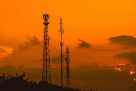 Silhouette telecommunications antenna for mobile phone at sunsetの写真素材