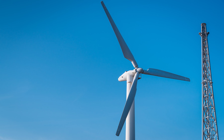 Wind turbine farm on blue sky background.