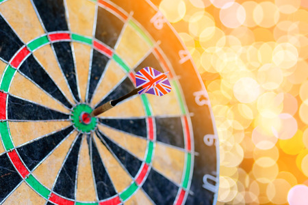 Selective focus of dart UK flag in old target dart with bokeh background.