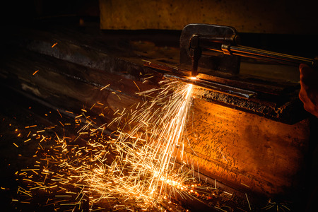 Worker cutting steel with acetylene welding cutting torch.の写真素材