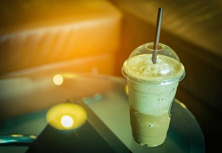 Cold coffee on glass table at cafe. Vintage tone. Soft focusの写真素材