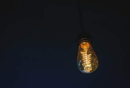 Light bulb glowing in the dark.の写真素材