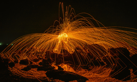 Burning steel wool on stone near the beach.