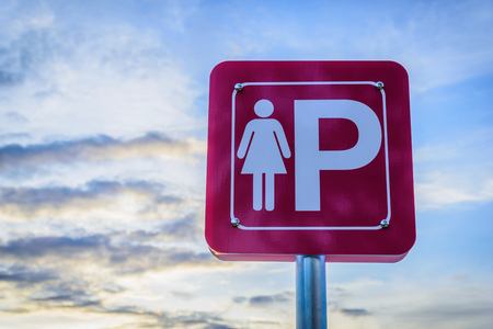 Lady parking metal sign on blue sky background.の写真素材