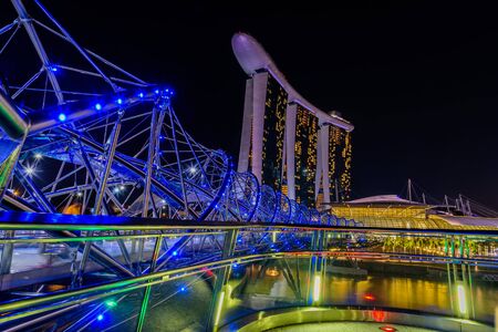 SINGAPORE - JULY 8,2016 : Helix Bridge and Marina Bay Sand Hotel at night time landmark in Singapore.のeditorial素材