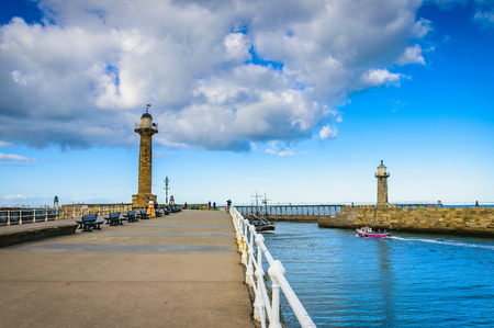 Whitby pier at the harbor entrance at Whitby in North Yorkshire, UKの写真素材