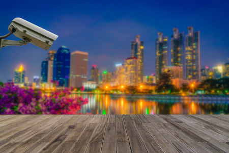 Closed Circuit Television camera monitoring of Benchakitti Park at night sky in Bangkok, Thailand.
