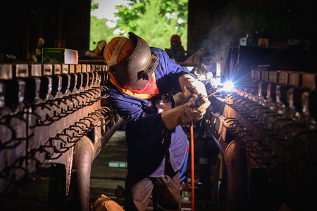 Welding steel structures and bright sparks in steel construction industry.