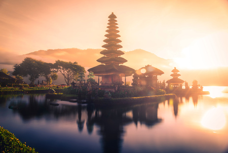 Pura Ulun Danu Bratan, Hindu temple on Bratan lake landscape with lens flare at sunrise in Bali, Indonesia.の写真素材