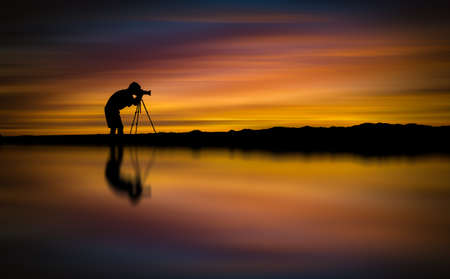 Silhouette Photographer take photo beautiful seascape at sunset in Thailandの写真素材
