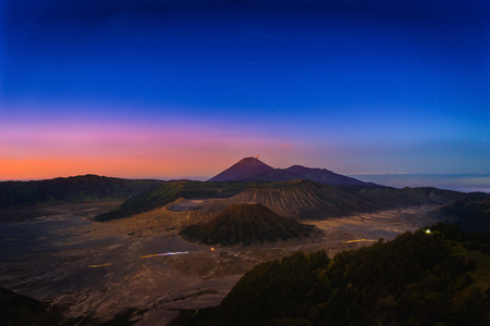 Mount Bromo volcano (Gunung Bromo) at sunrise with star trail in Bromo Tengger Semeru National Park, East Java, Indonesia.の写真素材