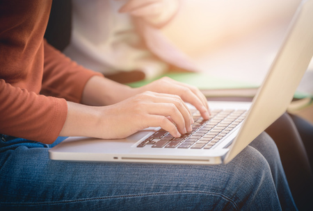 Young woman using laptop computer at outside office.の写真素材