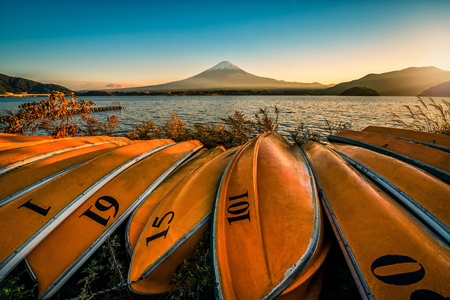 Mt. Fuji over Lake Kawaguchiko with boats at sunset in Fujikawaguchiko, Japan.のeditorial素材