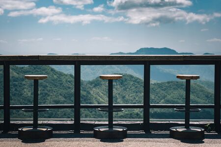 Tables and chairs on the terrace with view mountain and sky. Vintage toneの写真素材