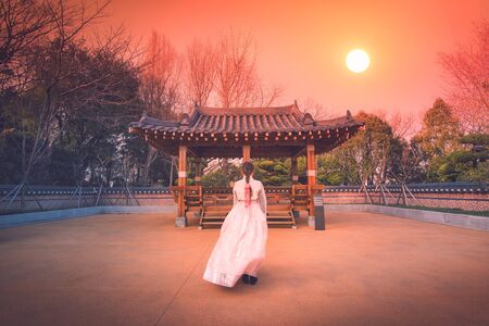 Asian korean Girls dressed Hanbok in traditional dress at sunset in South Korea.の写真素材